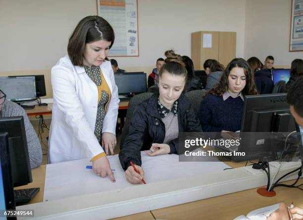 Kamza, Albania IT training of young people in a vocational school. A teacher instructs her student on March 28, 2017 in Kamza, Albania.