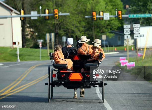 Amish family ride an amish horse in Central Pennsylvania, United States on April 30, 2017. Central Pennsylvania is home to an iconic set of plain...