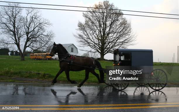 An Amish horse and a buggy are seen on the road in Central Pennsylvania, United States on April 30, 2017. Central Pennsylvania is home to an iconic...