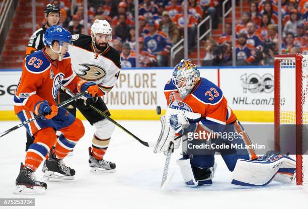 Matthew Benning and goalie Cam Talbot of the Edmonton Oilers defend the net against Nate Thompson of the Anaheim Ducks in Game Three of the Western...