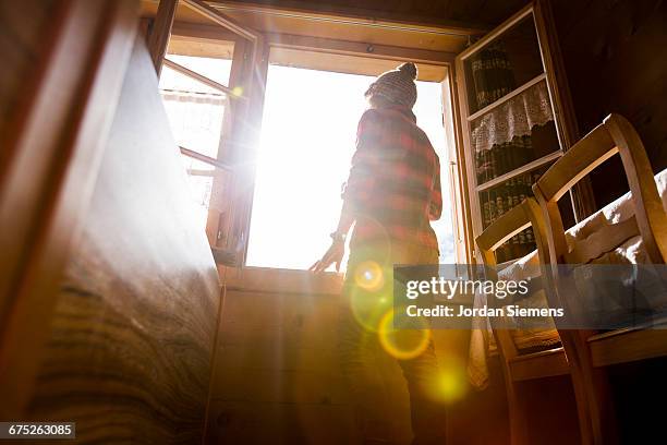 a woman taking in the view form her room - window glare stock pictures, royalty-free photos & images