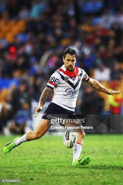 Mitchell Pearce of the Roosters kicks the ball through during the round nine NRL match between the New Zealand Warriors and the Sydney Roosters at Mt...