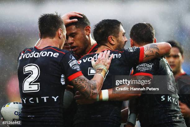 David Fusitu'a of the Warriors celebrates with Charnze Nicoll-Klokstad and Shaun Johnson after scoring a try during the round nine NRL match between...