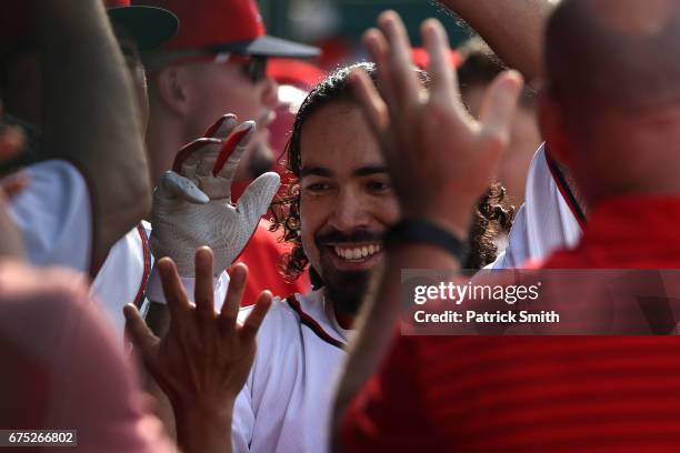 Anthony Rendon of the Washington Nationals celebrates with teammates in the dugout after scoring on his solo home run during the eighth inning...