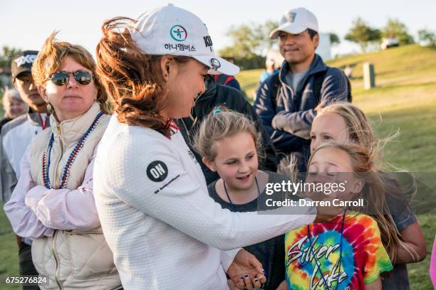 Minjee Lee of Australia talks with young fans at the 18th green during the final round of the Volunteers of America North Texas Shootout at Las...