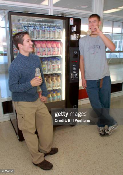 Ryan Gall and Howard Whitefoot , both students at Churchill High School in Livonia, Michigan, hang around the new milk vending machine December 3,...