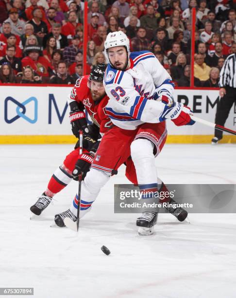 Mika Zibanejad of the New York Rangers skates against Viktor Stalberg of the Ottawa Senators in Game Two of the Eastern Conference Second Round...