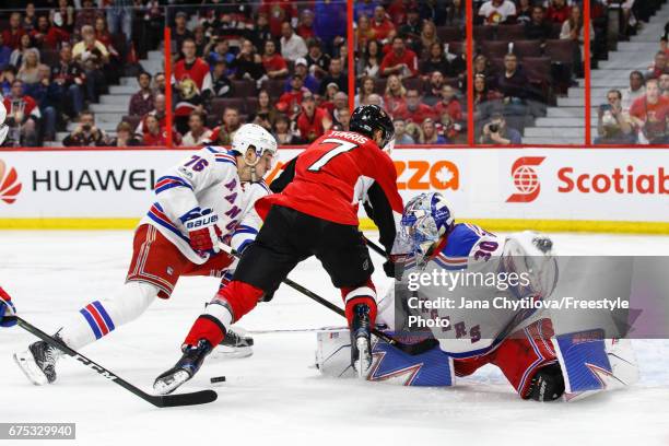 Henrik Lundqvist of the New York Rangers makes a pad save against Kyle Turris of the Ottawa Senators as Brady Skjei of the New York Rangers defends...