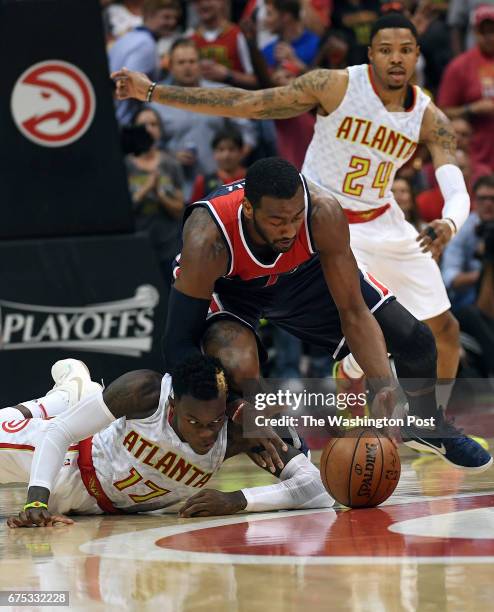 Washington Wizards guard John Wall beats Atlanta Hawks guard Dennis Schroder to a loose ball during the second half of Game Six of the NBA Playoffs...