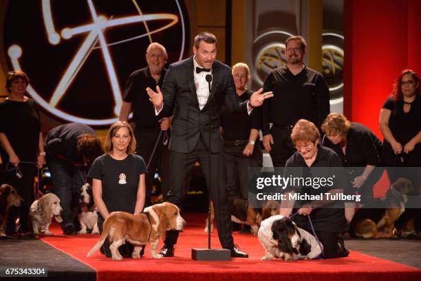 Brandon McMillan speaks on stage with the dogs of DaphneyLand Basset Rescue and their handlers at the 44th annual Daytime Emmy Awards at Pasadena...