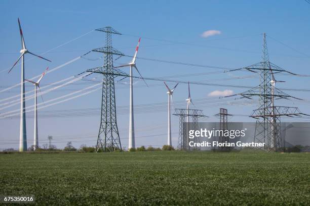 Power poles and wind turbines are captured on April 30, 2017 in Wustermark, Germany.