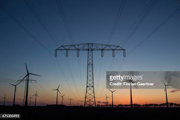 Power poles and wind turbines are captured on April 30, 2017 in Nauen, Germany.