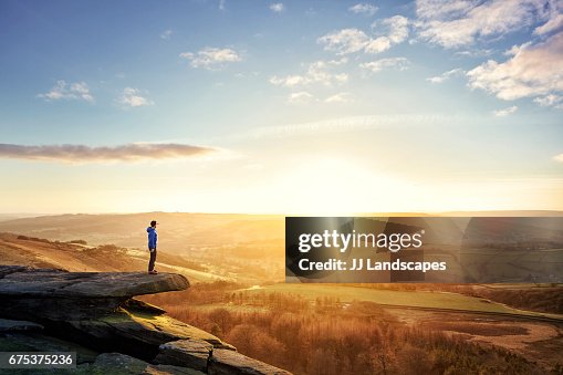 Hiker looking out at sunset Hiker looking out at sunset