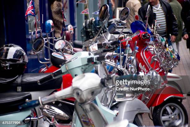 The Mods are pictured while gather with their scooters at Carnaby Street, London on April 30, 2017. Tens of Italian scooters appeared at the world...