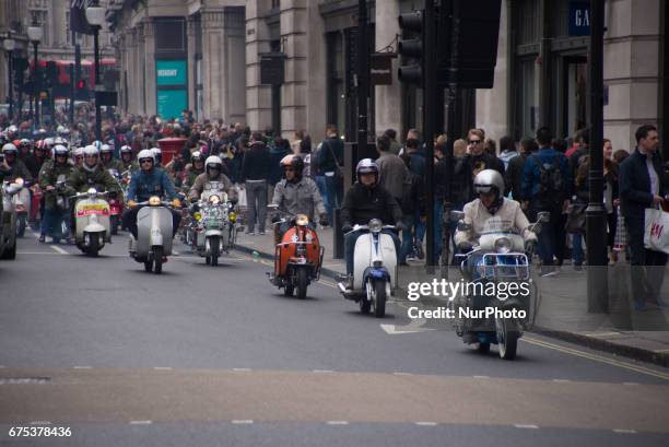 The Mods are pictured while gather with their scooters at Carnaby Street, London on April 30, 2017. Tens of Italian scooters appeared at the world...