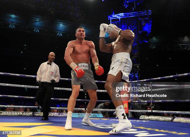 Anthony Joshua catches Wladimir Klitschko with a right hand upper cut in the 11th round of their IBF, WBA and IBO Heavyweight World Title bout at...