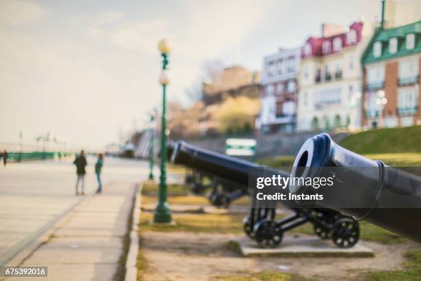 in quebec city, cannons of dufferin terrace, promenade right above the st lawrence river not far from the château frontenac hotel. - quebec city stock pictures, royalty-free photos & images