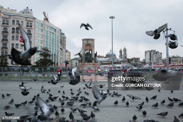 Turkish police officers stand guard on Taksim square in Istanbul on May 1 which is closed to prevent banned May Day demonstrations. Turkish police...