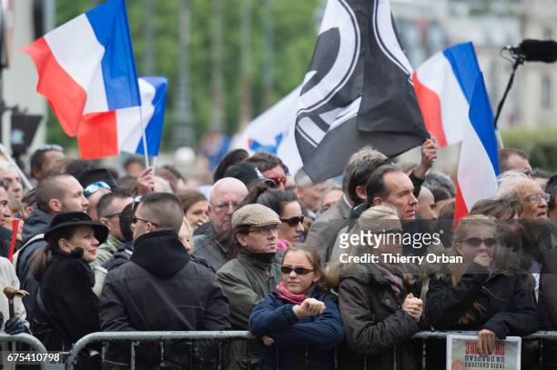People listen as France's far-right political party Front National founder, Jean-Marie Le Pen honors Jeanne d'Arc "The Maid of Orléans" during a...