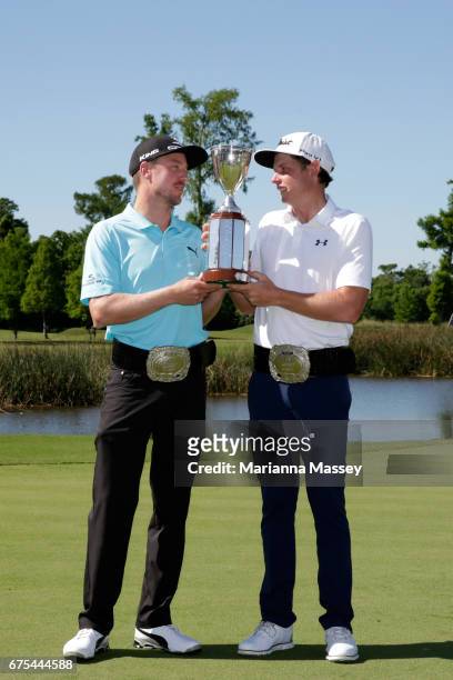 Jonas Blixt of Sweden and Cameron Smith of Australia pose with the trophy after winning in a sudden-death playoff during a continuation of the final...