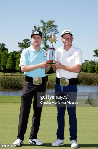 Jonas Blixt of Sweden and Cameron Smith of Australia pose with the trophy after winning in a sudden-death playoff during a continuation of the final...