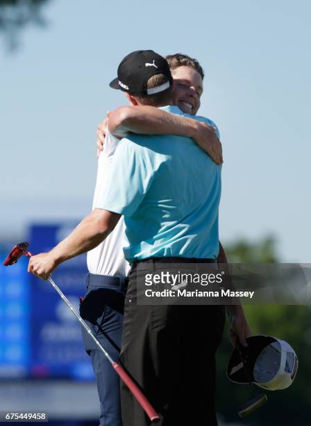 Cameron Smith of Australia and Jonas Blixt of Sweden react after putting in to win in a sudden-death playoff during a continuation of the final round...