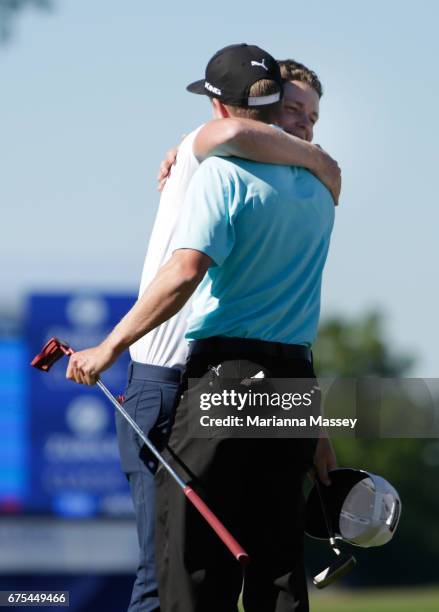 Cameron Smith of Australia and Jonas Blixt of Sweden react after putting in to win in a sudden-death playoff during a continuation of the final round...