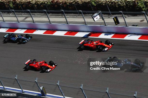 Valtteri Bottas driving the Mercedes AMG Petronas F1 Team Mercedes F1 WO8 leads Sebastian Vettel of Germany driving the Scuderia Ferrari SF70H, Kimi...