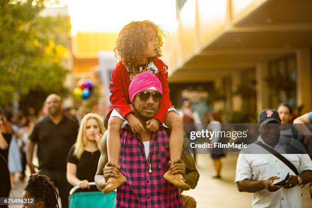 Nick Cannon and Moroccan Cannon visit Disneyland on April 30, 2017 in Anaheim, California.