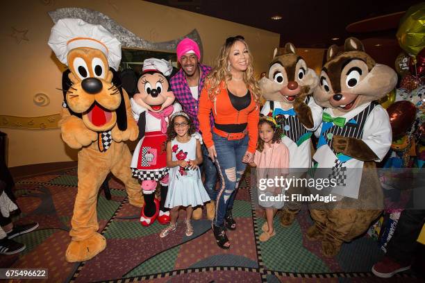 Monroe Cannon, Nick Cannon, Mariah Carey, and Moroccan Cannon pose with Disney characters at Disneyland on April 30, 2017 in Anaheim, California.