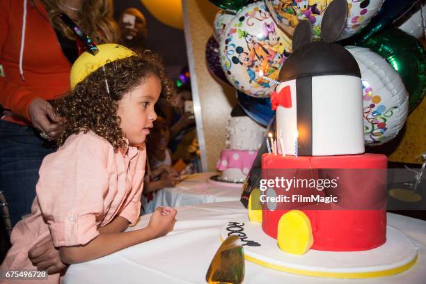 Moroccan Cannon blows out candles on his birthday cake at Disneyland on April 30, 2017 in Anaheim, California.
