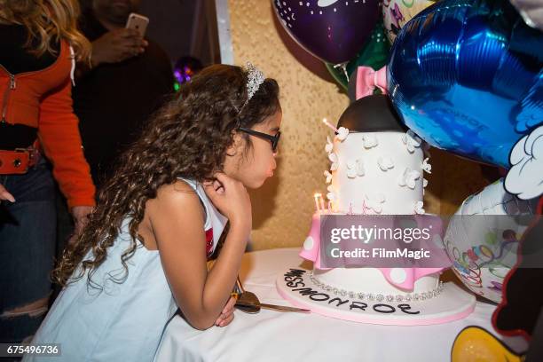 Monroe Cannon blows out candles on her birthday cake at Disneyland on April 30, 2017 in Anaheim, California.