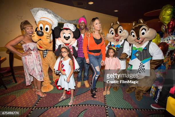 Beth Hackett, Monroe Cannon, Nick Cannon, Mariah Carey, and Moroccan Cannon pose with Disney characters at Disneyland on April 30, 2017 in Anaheim,...