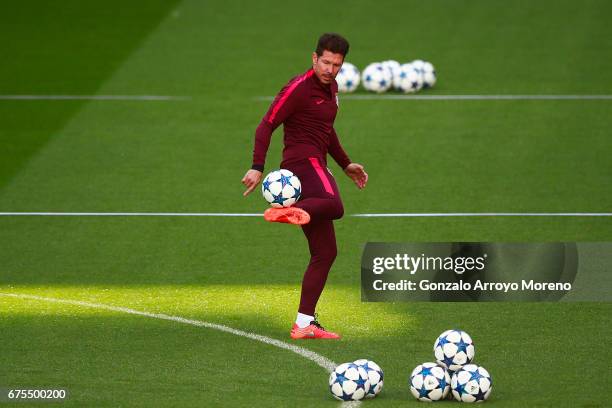 Head coach Diego Pablo Simeone of Atletico de Madrid kicks the ball during a training session ahead of the UEFA Champions League Semifinal First leg...