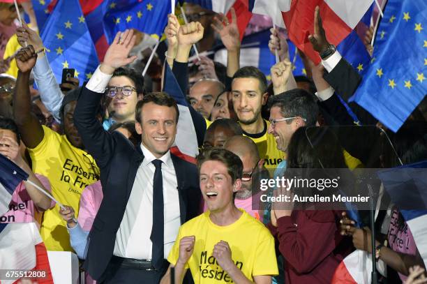 French Presidential Candidate Emmanuel Macron salutes voters after a political meeting at Grande Halle de La Villette on May 1, 2017 in Paris,...