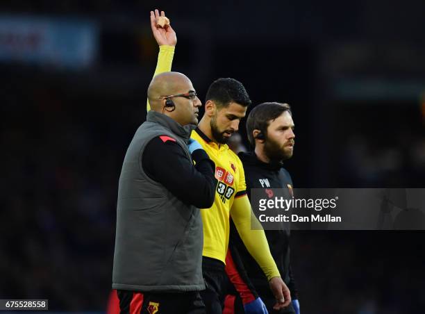 The injured Miguel Angel Britos of Watford leaves the field during the Premier League match between Watford and Liverpool at Vicarage Road on May 1,...