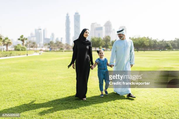 happy familywalking in the park - dubai park stock pictures, royalty-free photos & images