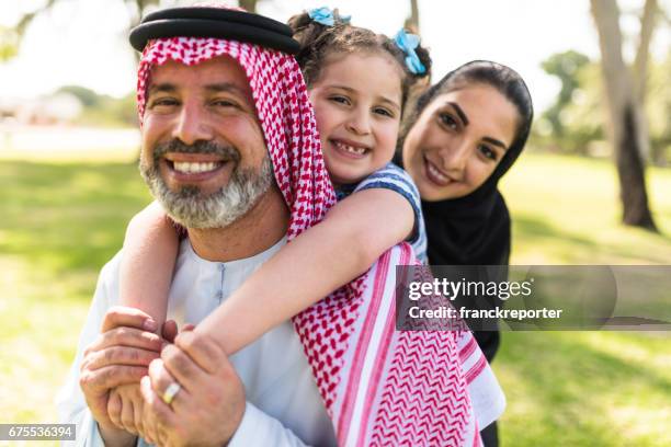 happy saudi arabian family in the park - saudi people stock pictures, royalty-free photos & images