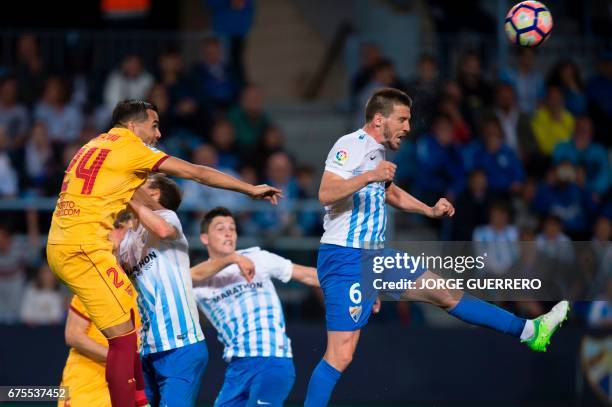 Sevilla's Argentinian defender Gabriel Mercado vies with Malaga's midfielder Ignacio Camacho during the Spanish league football match Malaga CF vs...