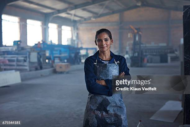 portrait of female worker at factory - blue collar portrait stock-fotos und bilder