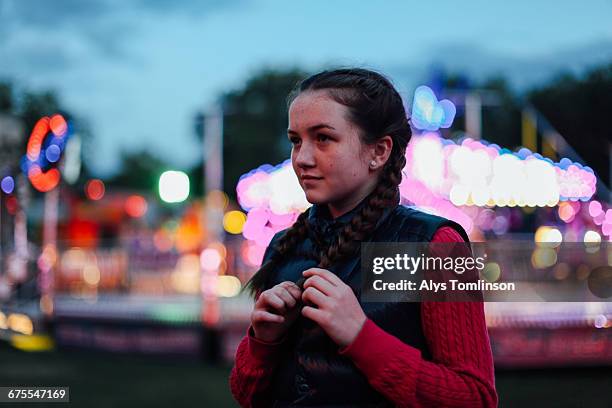 portrait of teenage girl at funfair at dusk - unfilteredtrend stock pictures, royalty-free photos & images