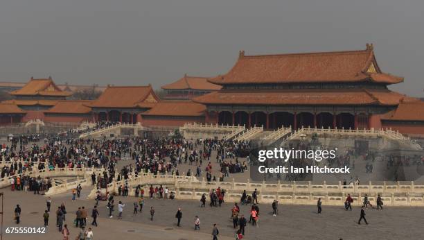 Tourists are seen waking through the grounds at the Forbidden City on April 3, 2017 in Beijing, China