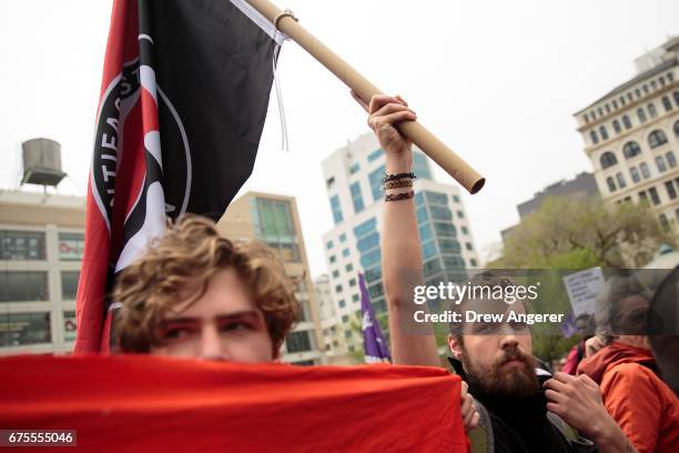 Two demonstrators, who said they were 'anti-fascist activists,' rally during a May Day rally in Union Square, May 1, 2017 in New York City. Across...