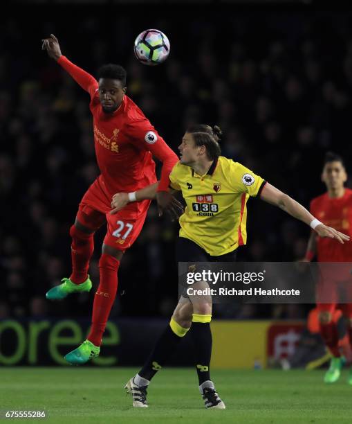 Divock Origi of Liverpool heads the ballunder pressure from Sebastian Prodl of Watford during the Premier League match between Watford and Liverpool...