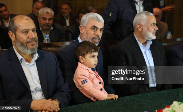 Yahya Sinwar , the new leader of the Hamas Islamist movement in the Gaza Strip and senior political leader Ismail Haniyeh attend a gathering to watch...