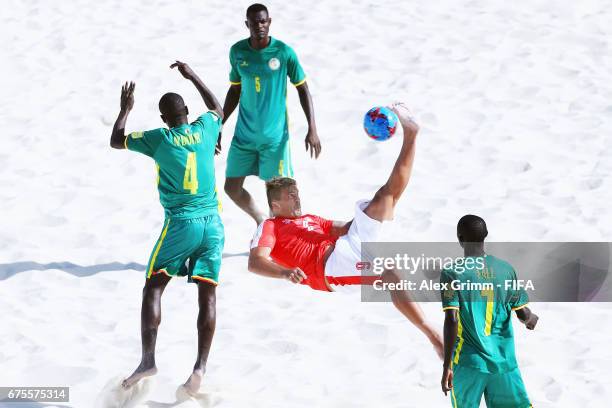 Dejan Stankovic of Switzerland attempts a bicycle kick between Papa Ndour, Mamadou Sylla and Babacar Fall of Senegal during the FIFA Beach Soccer...