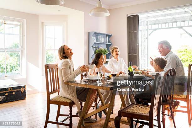 happy family enjoying lunch at home - family dinner table stockfoto's en -beelden