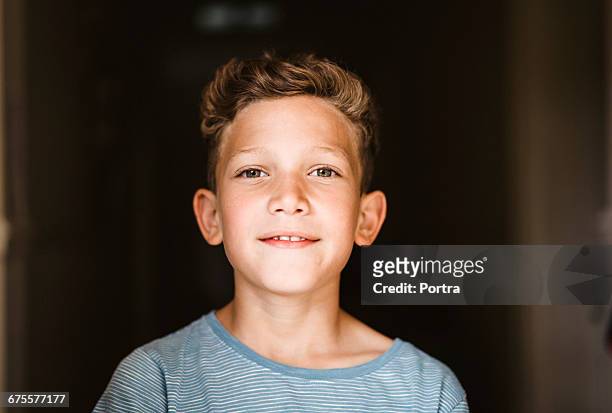 close-up portrait of smiling boy at home - tweenies stockfoto's en -beelden