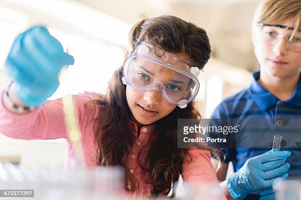 students doing scientific experiment in classroom - stem education stock pictures, royalty-free photos & images
