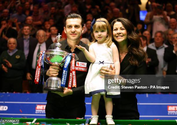 Mark Selby celebrates winning the Betfred Snooker World Championship with his daughter Sofia Maria and wife Vikki Layton on day seventeen of the...